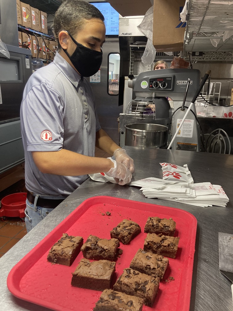 Former LIFE student packages brownies at Chick Fil A